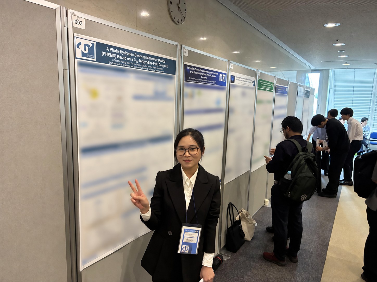 Huong Thi Mai Trinh with her poster at the anniversary symposium in Kobe.